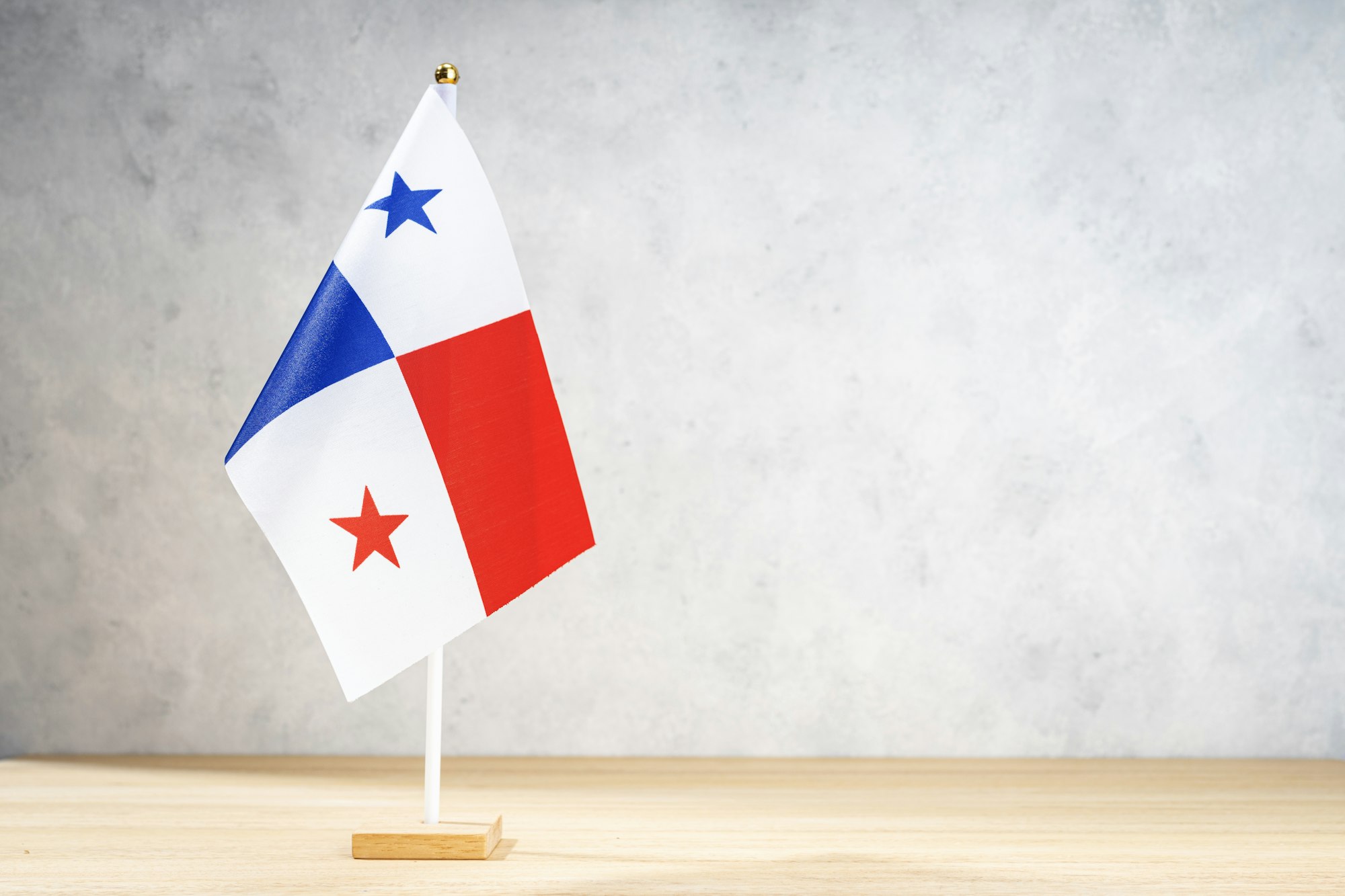 Panama table flag on white textured wall